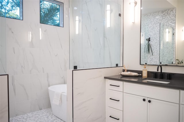 bathroom featuring vanity, separate shower and tub, and tile walls