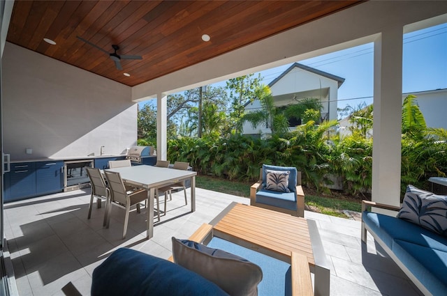 view of patio / terrace featuring sink, ceiling fan, outdoor lounge area, a grill, and an outdoor kitchen