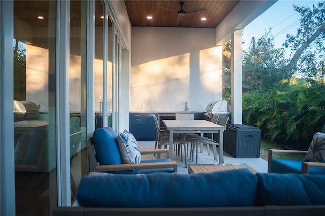 exterior space featuring sink, ceiling fan, outdoor lounge area, a grill, and an outdoor kitchen