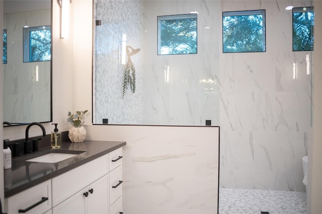 bathroom featuring vanity and tiled shower