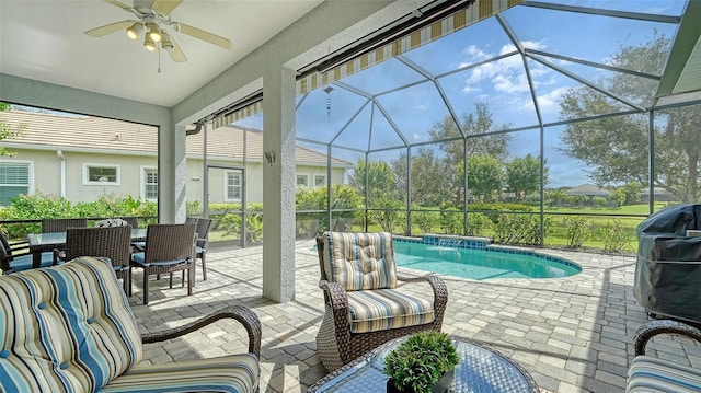 pool featuring a patio, glass enclosure, area for grilling, and a ceiling fan