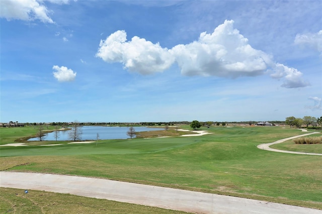 view of community featuring a lawn and a water view