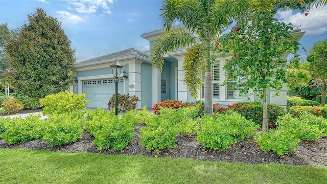 view of front of home featuring an attached garage and stucco siding