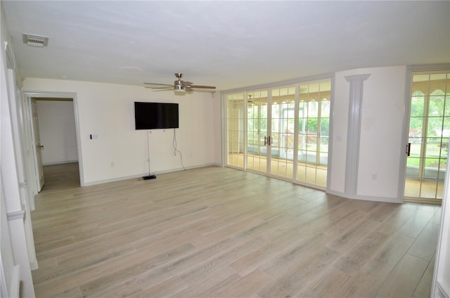 unfurnished room with ceiling fan and light hardwood / wood-style floors