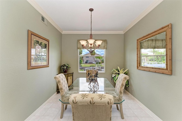 tiled dining space featuring crown molding and an inviting chandelier