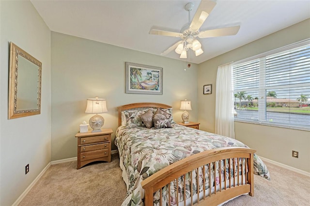 bedroom with ceiling fan and light carpet