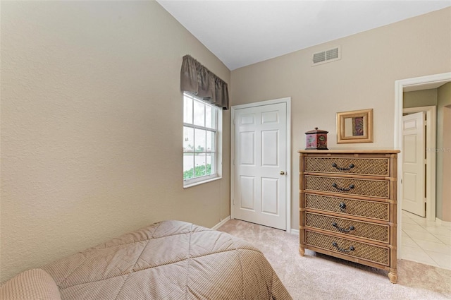 bedroom featuring light colored carpet