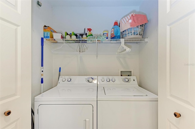 clothes washing area with washer and dryer