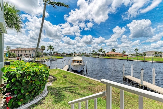 dock area featuring a water view and a lawn