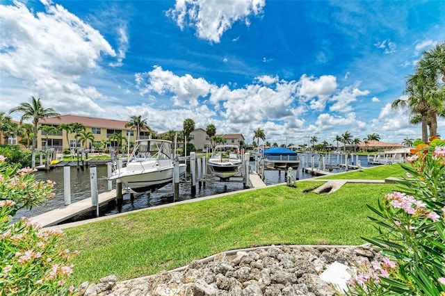 view of dock with a water view and a lawn