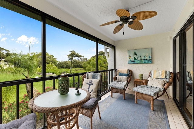 sunroom / solarium featuring ceiling fan