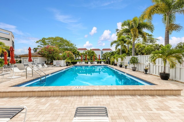 pool featuring a patio and fence