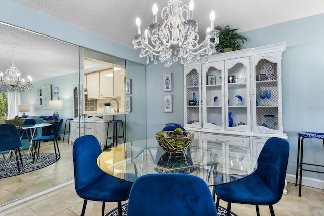 dining area featuring an inviting chandelier and a textured ceiling