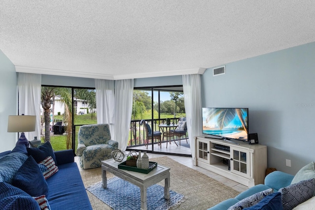 tiled living area with visible vents and a textured ceiling