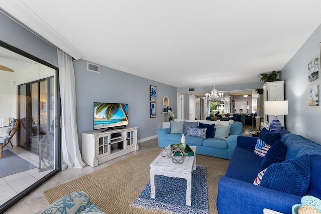 tiled living room featuring visible vents and a chandelier