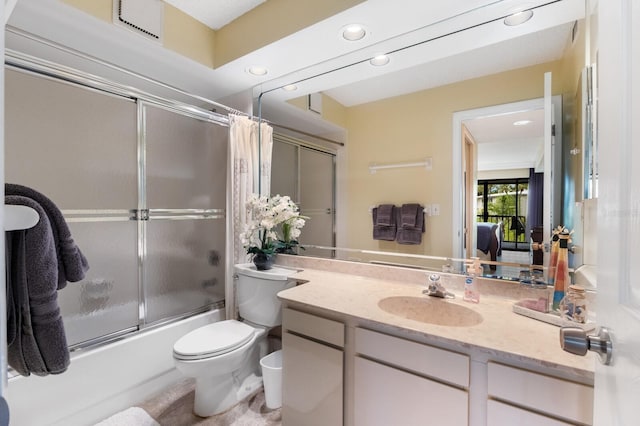 full bathroom with toilet, bath / shower combo with glass door, and vanity