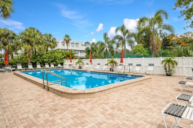 community pool featuring a patio area and fence