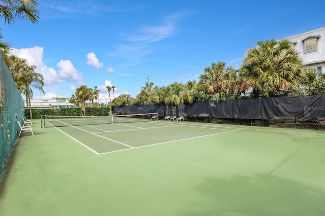 view of tennis court featuring fence