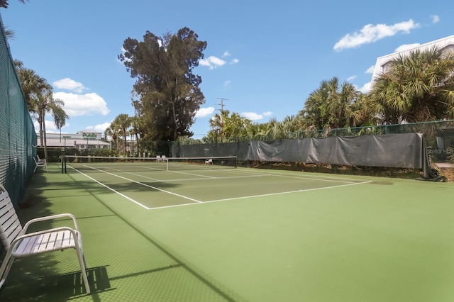 view of tennis court with fence