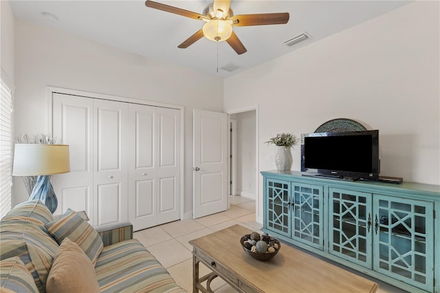 living room featuring ceiling fan and light tile floors