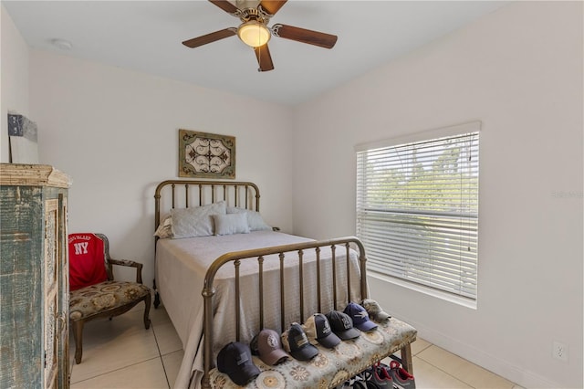 bedroom featuring ceiling fan and light tile floors