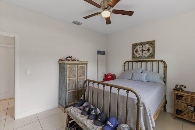 tiled bedroom featuring ceiling fan