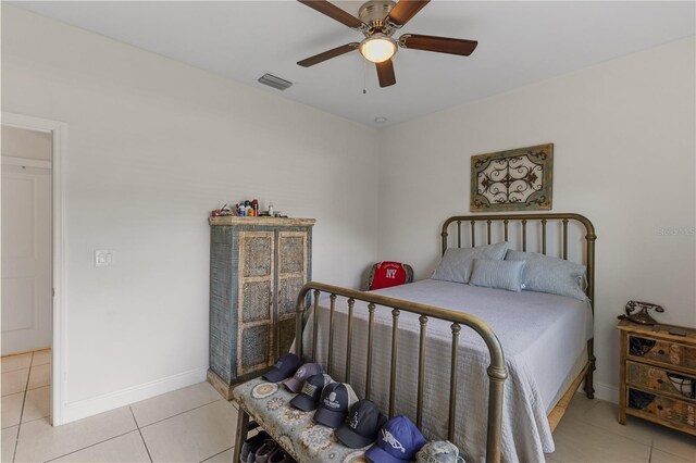 bedroom with light tile flooring and ceiling fan