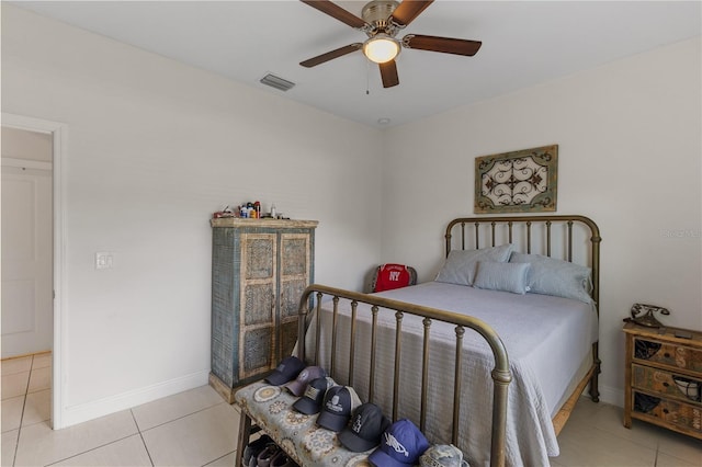 tiled bedroom featuring ceiling fan