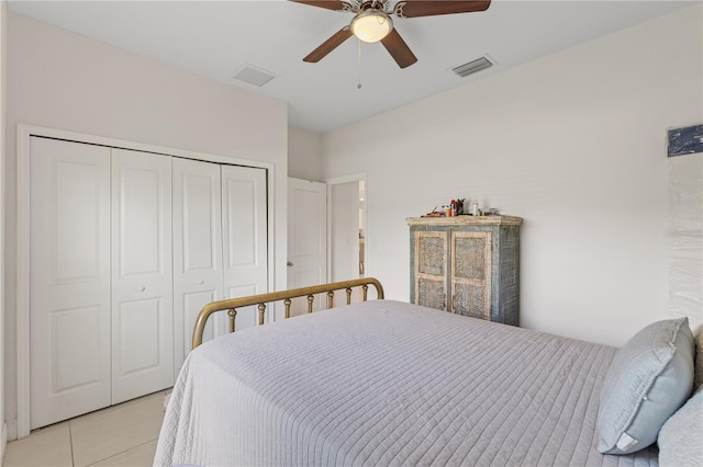 tiled bedroom featuring ceiling fan and a closet