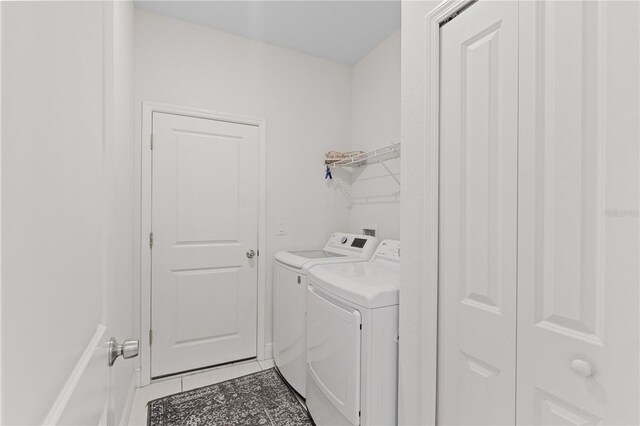 laundry room with washer and dryer, tile floors, and washer hookup