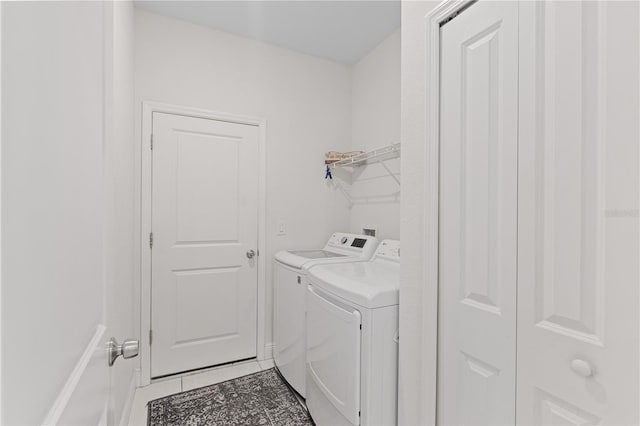 washroom featuring washing machine and clothes dryer and tile patterned flooring