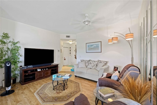 living room featuring ceiling fan and light hardwood / wood-style flooring