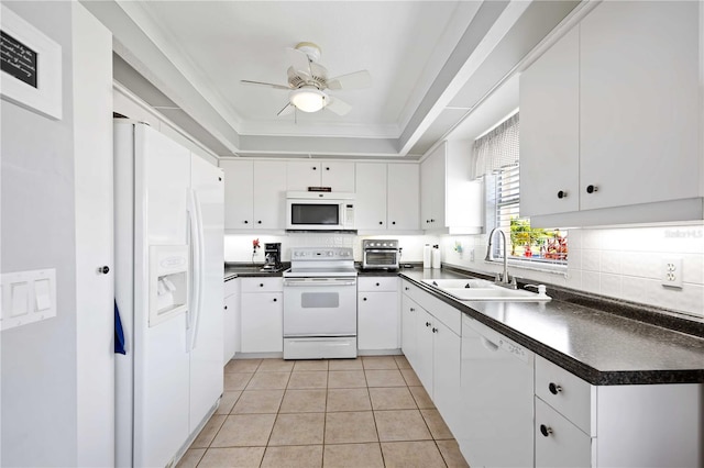 kitchen featuring sink, light tile patterned floors, white appliances, a tray ceiling, and white cabinets