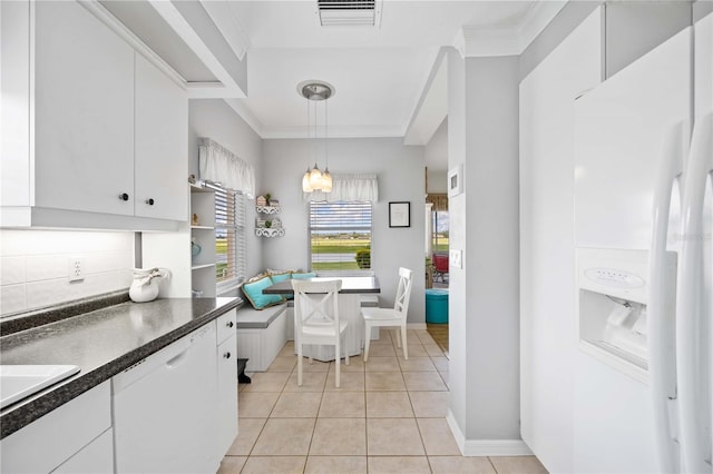 kitchen featuring white cabinets, light tile patterned flooring, white appliances, and hanging light fixtures