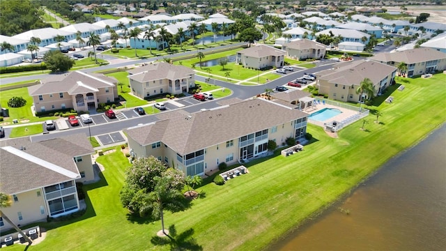 birds eye view of property with a water view