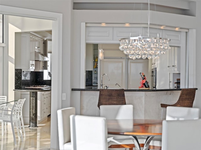 dining area with a notable chandelier and sink