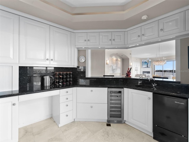 kitchen with wine cooler, white cabinetry, sink, and dark stone counters