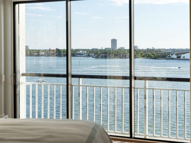 unfurnished bedroom with a water view and multiple windows