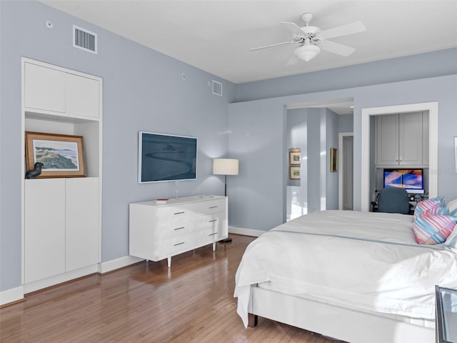 bedroom with hardwood / wood-style floors and ceiling fan