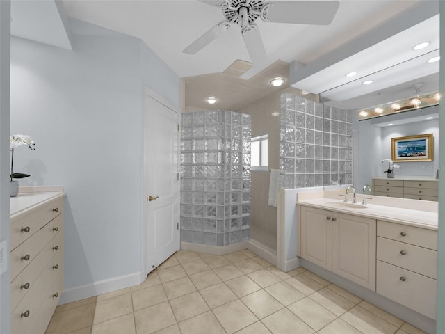 bathroom featuring tiled shower, vanity, tile patterned floors, and ceiling fan