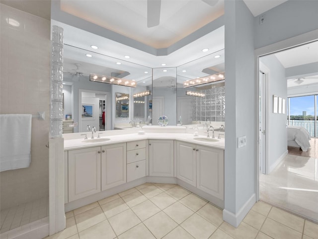 bathroom featuring tile patterned floors, ceiling fan, vanity, and tiled shower