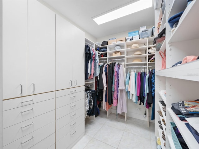 walk in closet featuring light tile patterned flooring