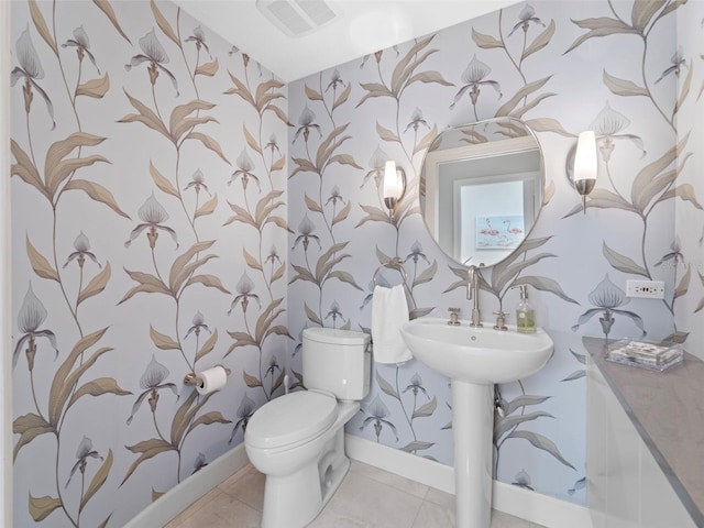 bathroom with tile patterned floors and toilet