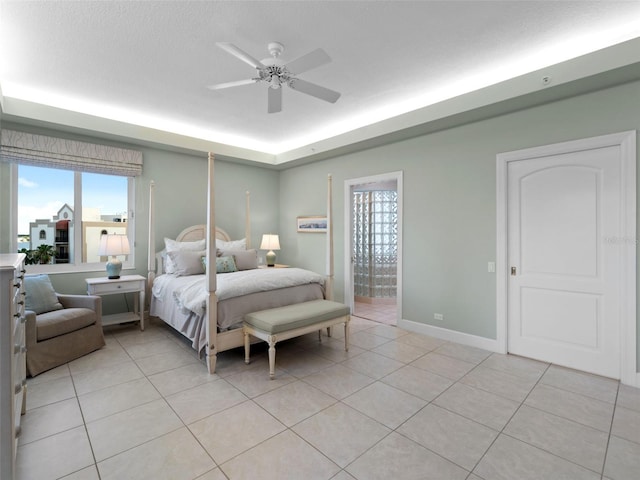 bedroom with light tile patterned floors, a textured ceiling, and ceiling fan