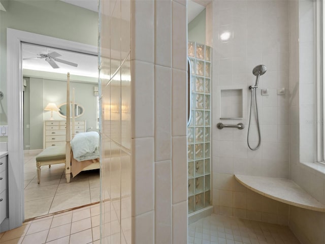 bathroom featuring tiled shower, vanity, ceiling fan, and tile patterned flooring