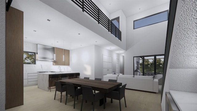 dining space with light hardwood / wood-style floors and sink