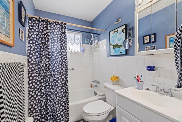 bathroom with toilet, a wainscoted wall, vanity, tile walls, and shower / tub combo with curtain