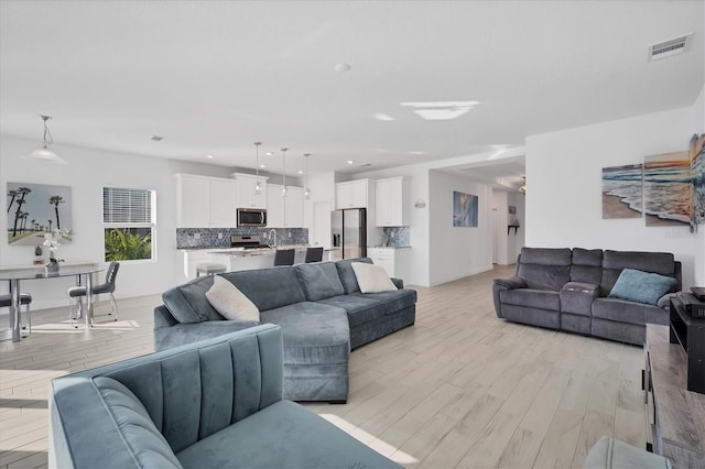 living room with light hardwood / wood-style floors