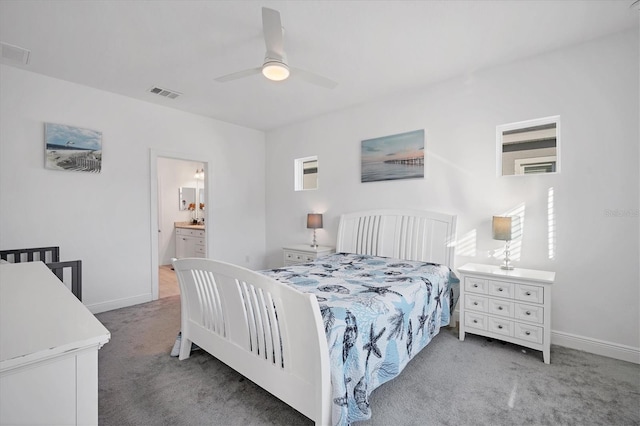 bedroom with carpet flooring, ensuite bath, and ceiling fan