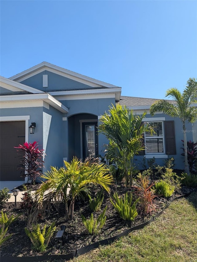 5415 Limelight Dr, Apollo Beach, FL 33572 - view of side of property featuring an attached garage and stucco siding